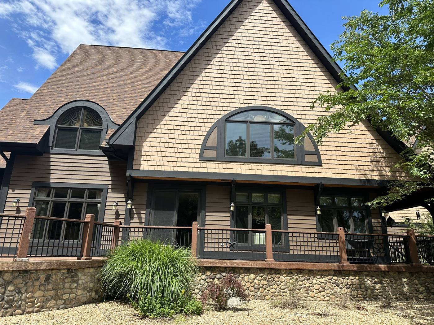 Cedar shake and lap siding with dark trim and window surrounds, painted by Cardinal Fine Painting